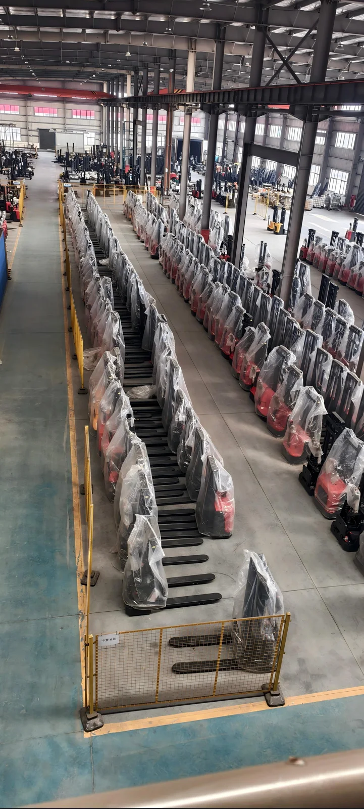 Rows of wrapped electric stackers in the warehouse