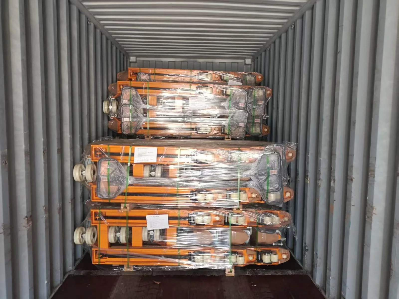 Wrapped hand pallet trucks loaded inside a shipping container